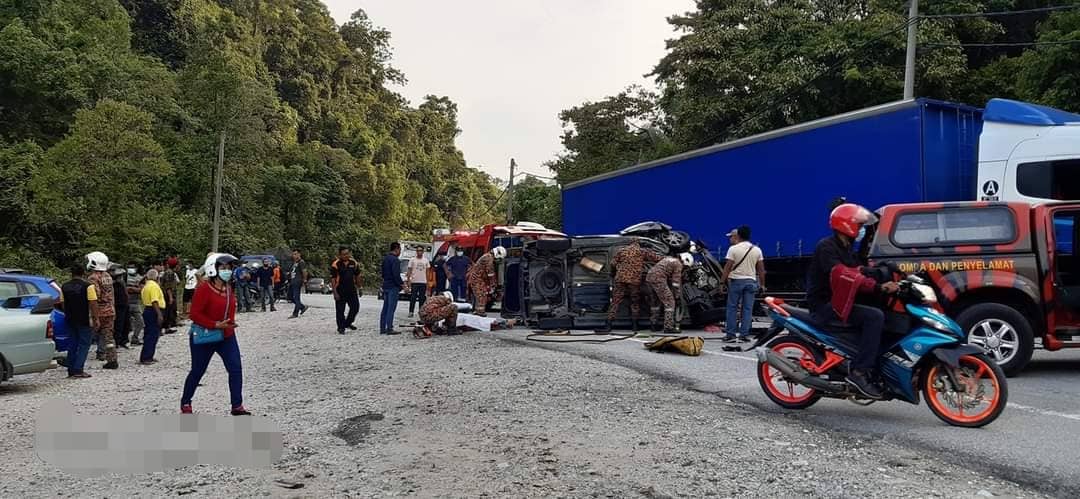 Anggota bomba cuba mengeluarkan mangsa yang tersepit di dalam kenderaan tersebut.