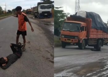Remaja baring di tengah jalan penuh lori
