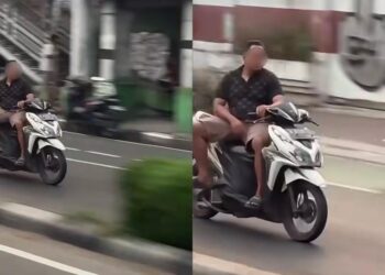 Lelaki bawa skuter duduk mengiring